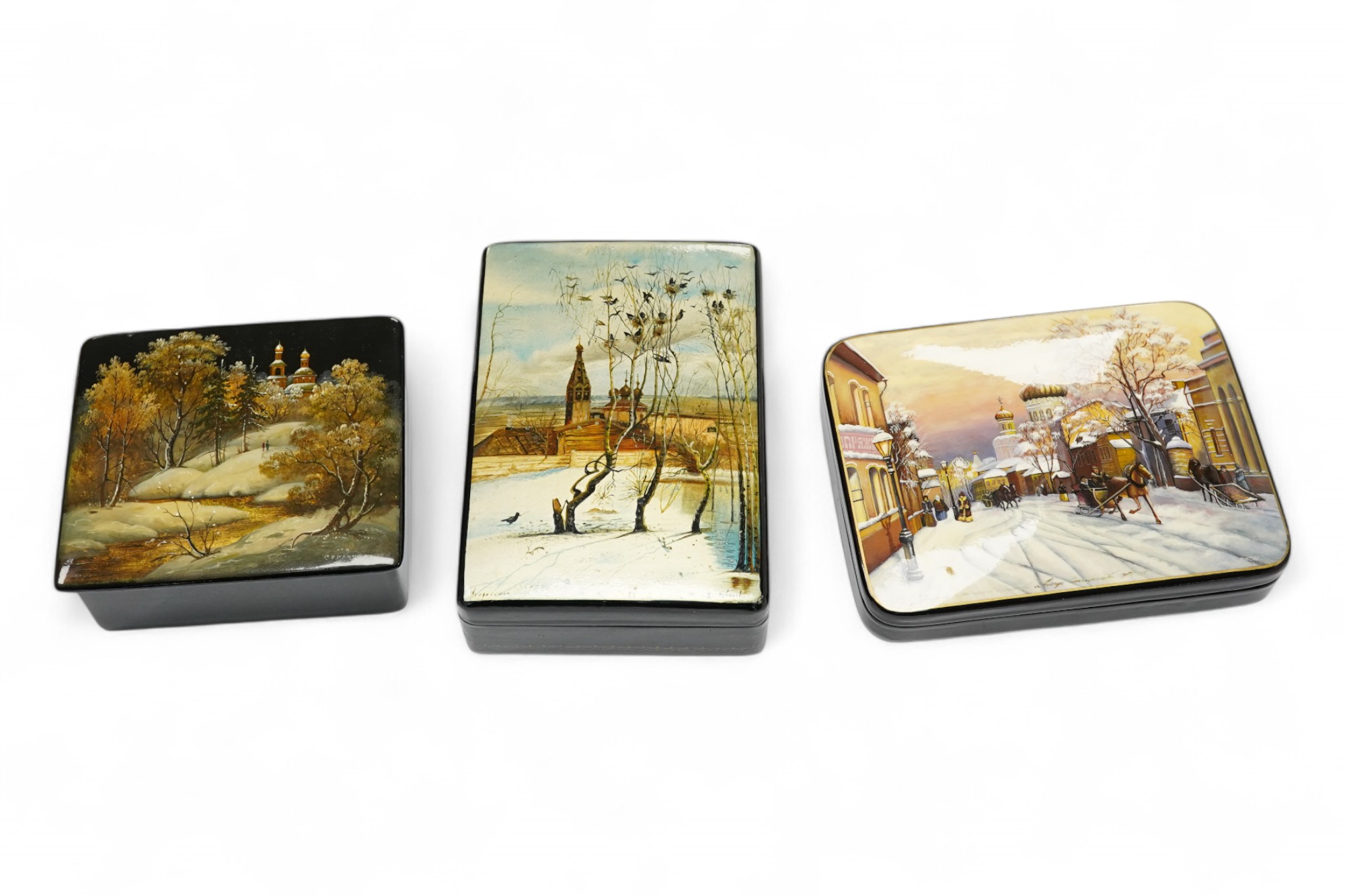 Three late 19th/early 20th century Russian lacquer boxes, decorated with snow scenes, largest 13.5cm. Condition - good